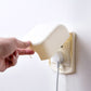 Child switch protective cover with curved top guard, cream and golden-yellow
