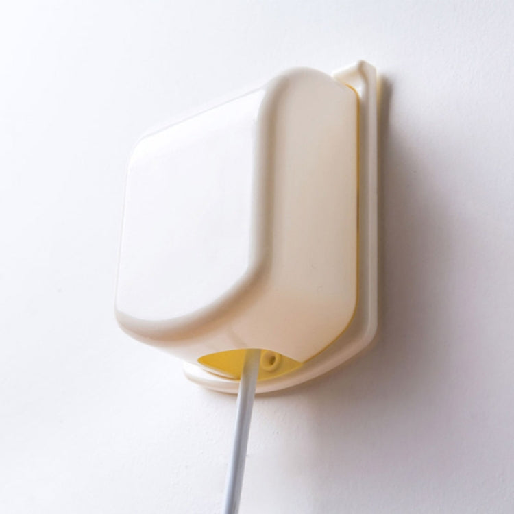 Child switch protective cover installed on outlet, cream with yellow safety tab