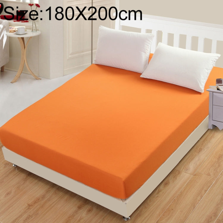 Orange fitted mattress protector cover with smooth surface and tucked edges