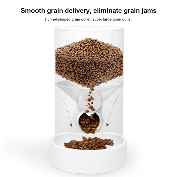 White automatic pet feeder with transparent hopper and kibble outlet, holding kibble