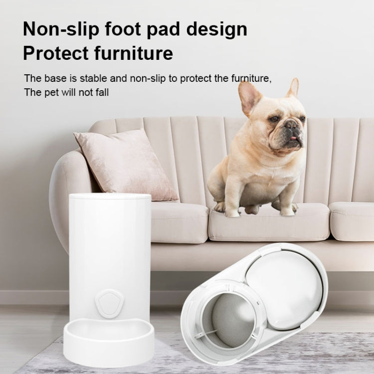 White automatic pet water and feeder unit with a dog sitting beside it on the floor