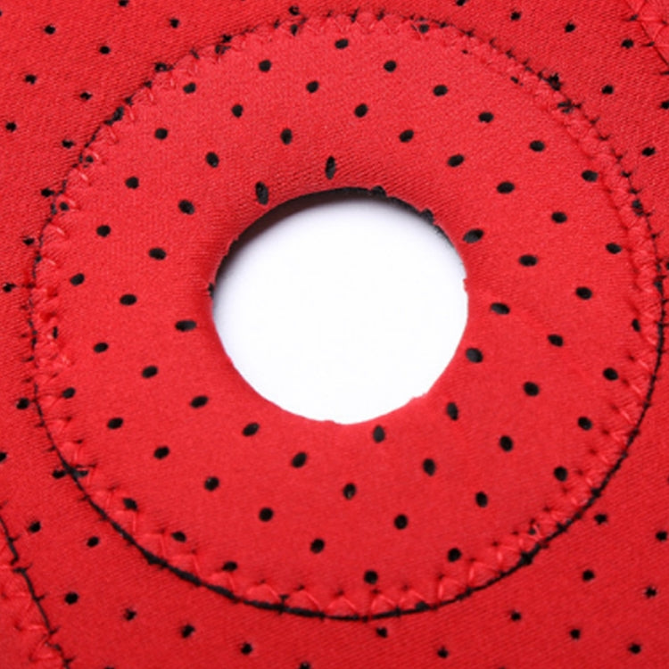Red knee pad fabric close-up with stitched round grip pad opening