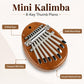 Brown 8-note kalimba instrument with silver metal keys on a compact wooden body