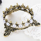 Gold-tone crown novelty pen holder with white pearl beads and ornate side details