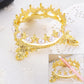 Gold-tone crown novelty pen holder with white pearl beads and decorative claw feet