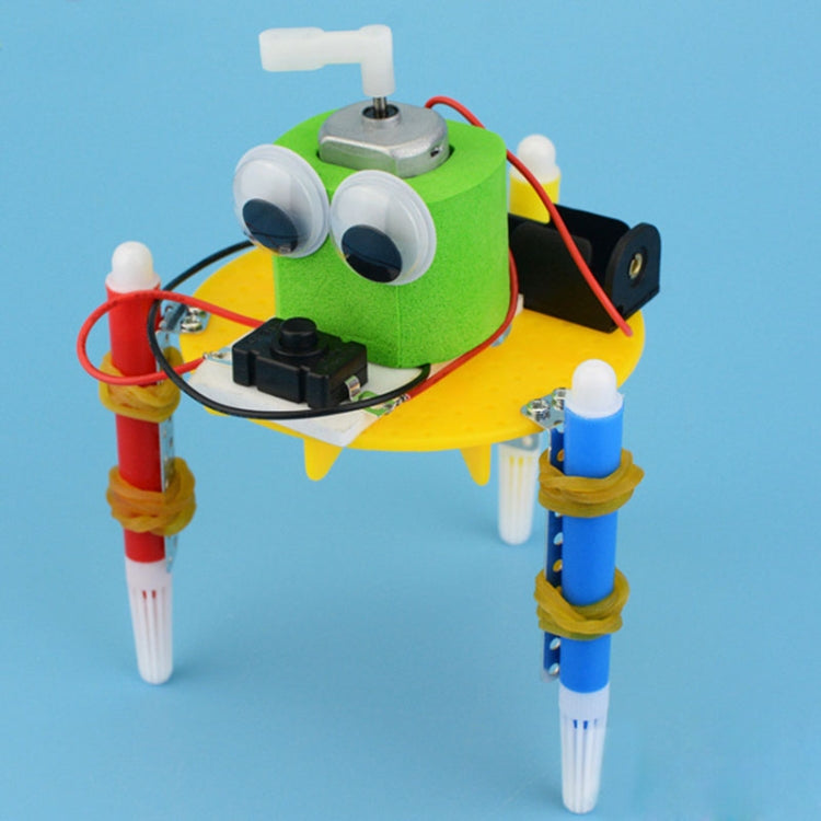 DIY solar robot toy with green head, two round white eyes, and red/blue legs