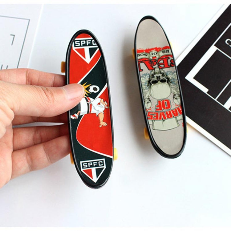 Mini finger skateboard set in hand: red-and-white deck plus skull-style deck with yellow wheels