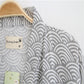 Gray wave-pattern cotton bathrobe collar and size label detail