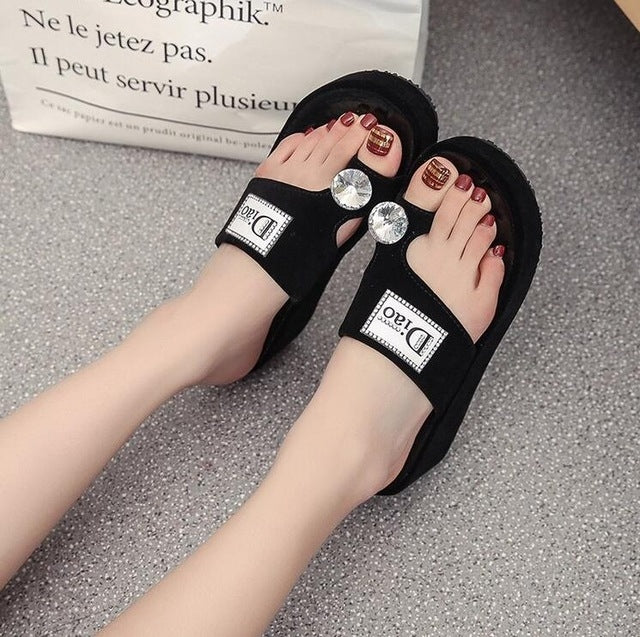 Black rhinestone platform slide sandals with crystal embellishments and open toe
