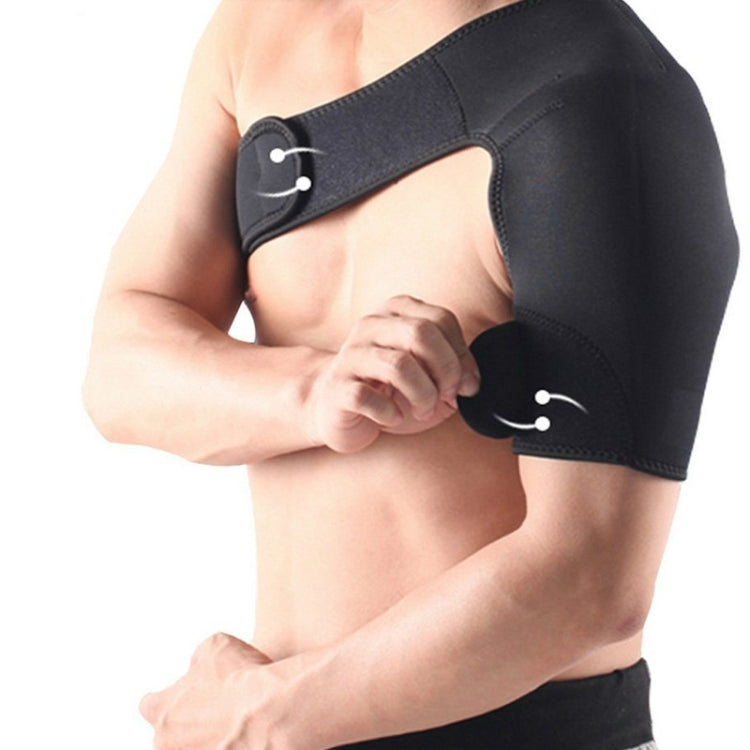 Black shoulder support brace with adjustable strap, worn and being adjusted by hand
