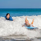 Blue inflatable kick board in waves with black strap handles