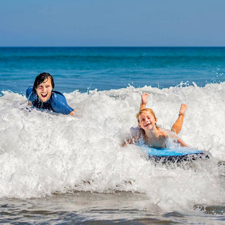 Blue inflatable kick board in waves with black strap handles