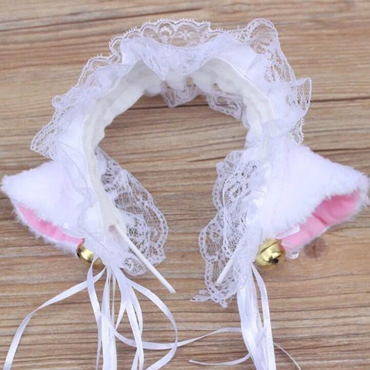White lace cat-ear headband with gold bell accents and pink-lined ears
