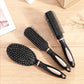Set of three black hair massage brushes with silver pins and oval pads.
