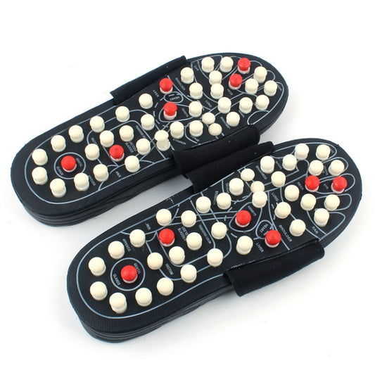 Black acupoint massage flip-flops with white and red raised nubs on the footbed