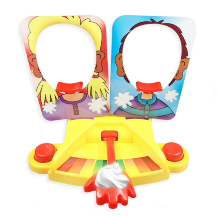 Pie face prank game toy with two character flip-up panels and a yellow launcher base