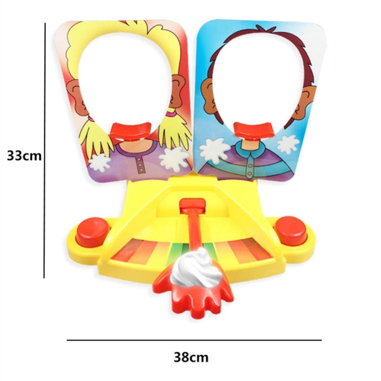 Pie face prank game toy with yellow base, two character panels, and red lever; size shown