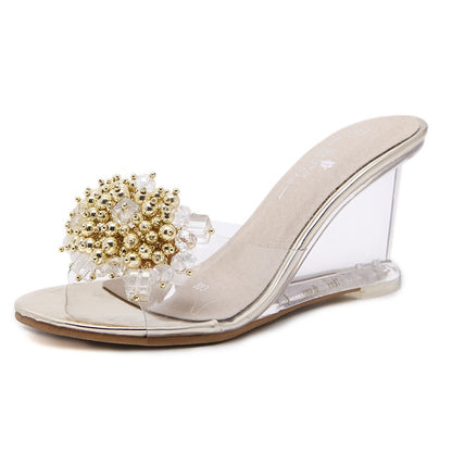 Gold rhinestone wedge mule with clear block heel and jeweled open-toe upper