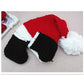 Knit baby romper with red top and white trim, black shorts, and black booties