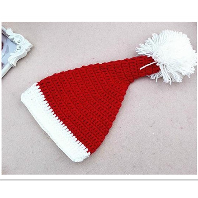 Knit baby Christmas hat with red crown, white brim, and white pom-pom