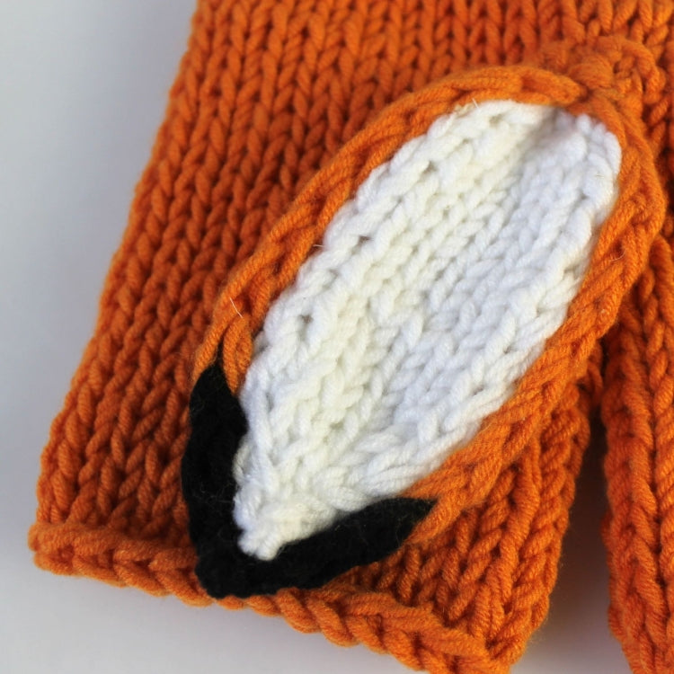 Orange knit fox hat and pants detail, textured stitches with white face patch