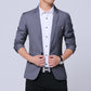 Men's gray blazer with notch lapels and chest pocket over a white button-up