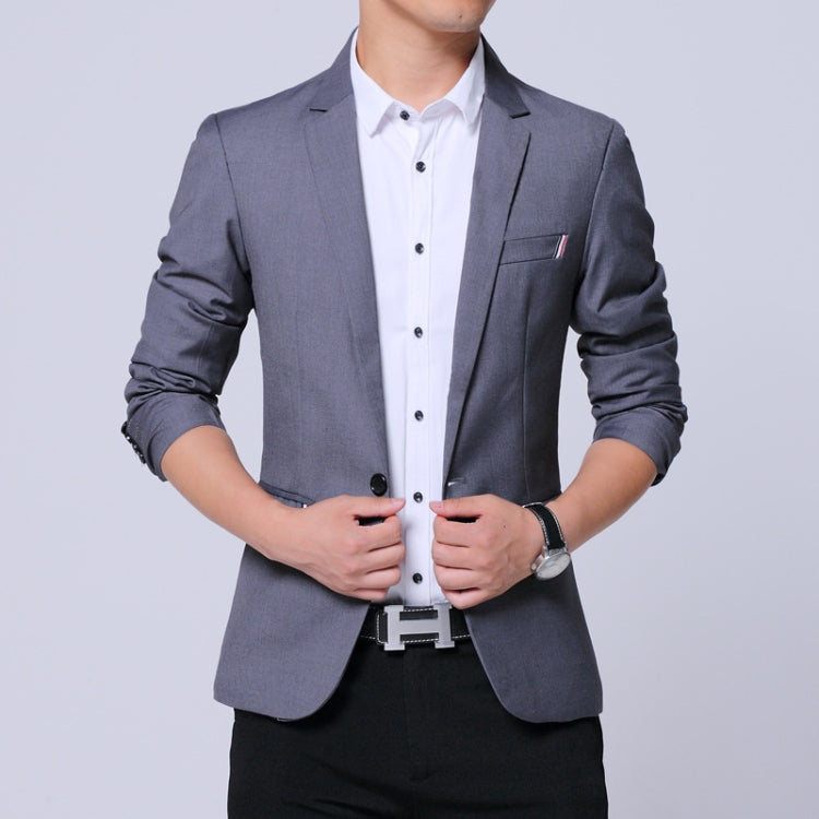 Men's gray blazer with notch lapels and chest pocket over a white button-up