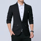 Men's black blazer with chest pocket and red pocket square, worn with white shirt