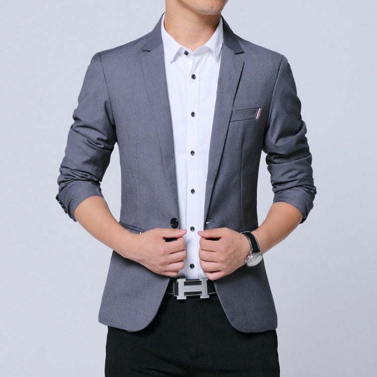 Men's gray blazer with notch lapels and chest pocket, worn with white button-up
