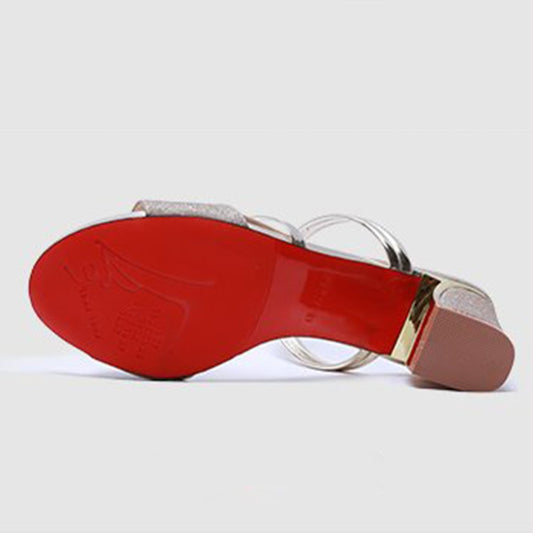 Open-toe sandal sole view with metallic straps and red outsole