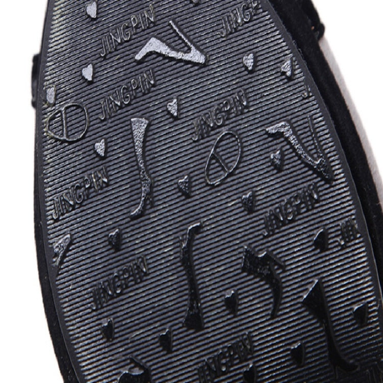 Close-up of black textured outsole with embossed grip pattern