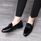 Men's black loafers with bowknot strap on feet, low heel and rounded toe