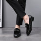 Men's black low-heel loafers with bowknot strap, side view on foot