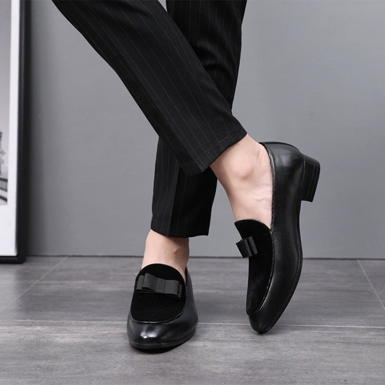 Men's black low-heel loafers with bowknot strap, side view on foot