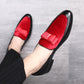 Men's red suede loafers with bowknot strap, close-up of front on foot