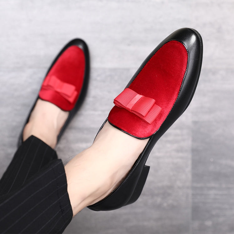 Men's red suede loafers with bowknot strap, close-up of front on foot