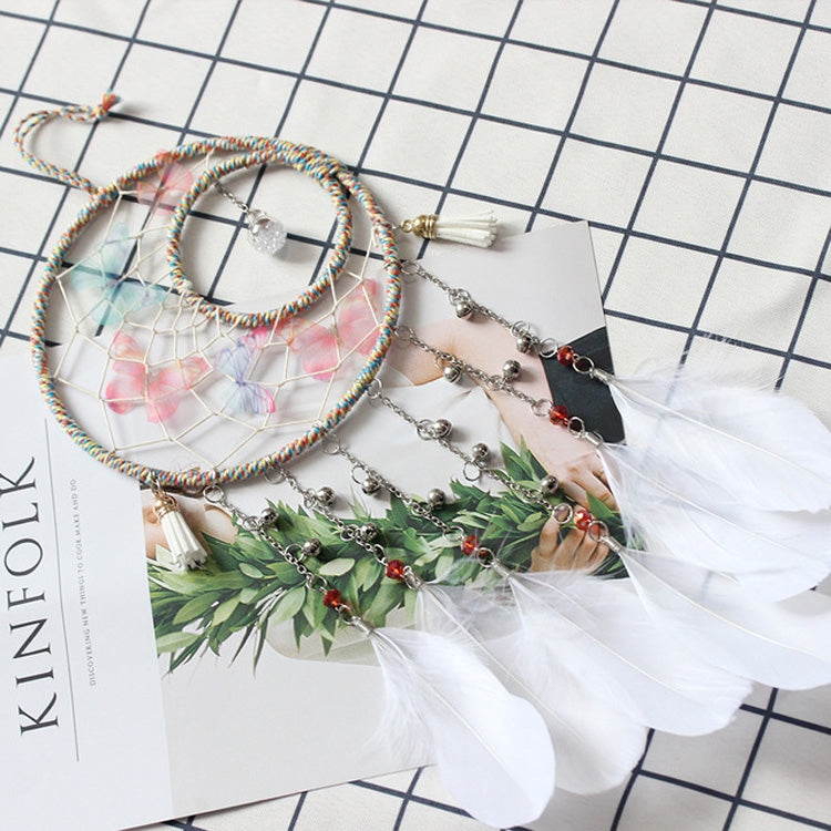 Dream catcher detail: beaded chains, multicolor hoops, and layered white feathers