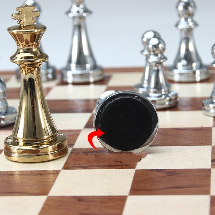 Gold chess piece and dark felt underside with arrow on a checkered board
