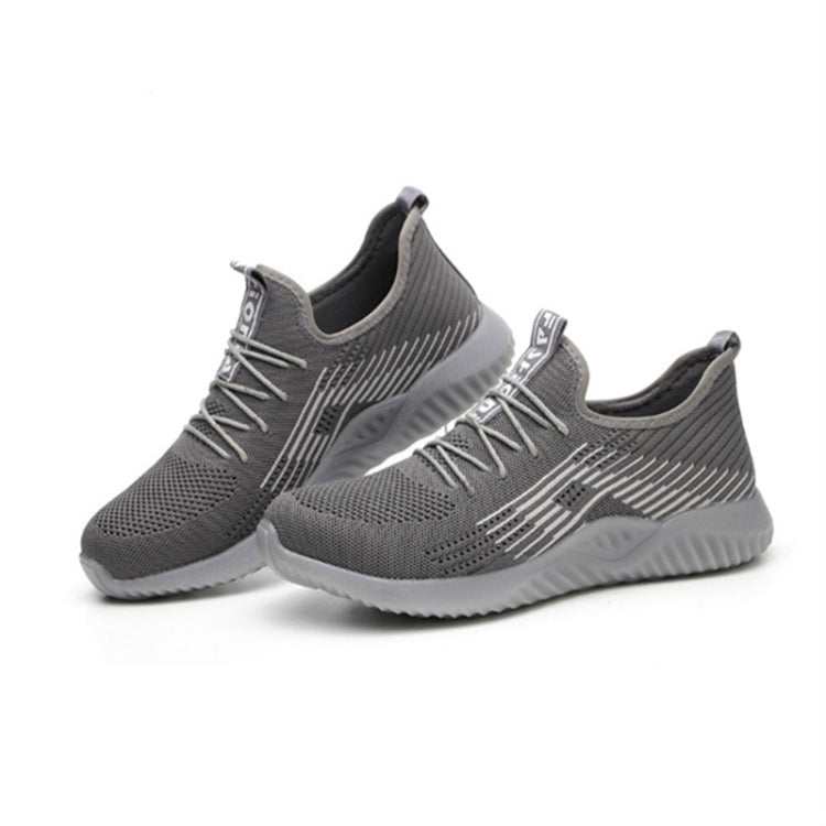 Grey work sneakers showing lace-up upper and padded collar with textured tread sole