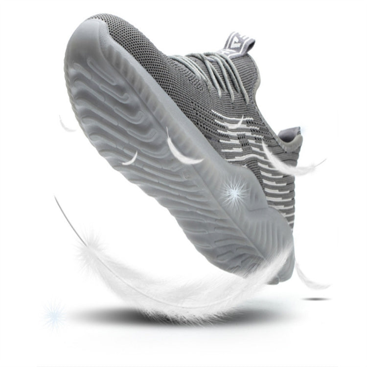 Grey lace-up work shoe with side view of treaded sole and knit paneling