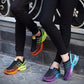 Pair of women’s lace-up mesh sneakers on pavement in black and purple with air sole