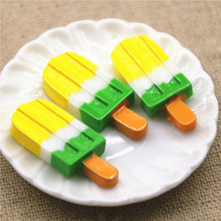 Yellow, green and orange striped ice cream stick resin cabochons on plate