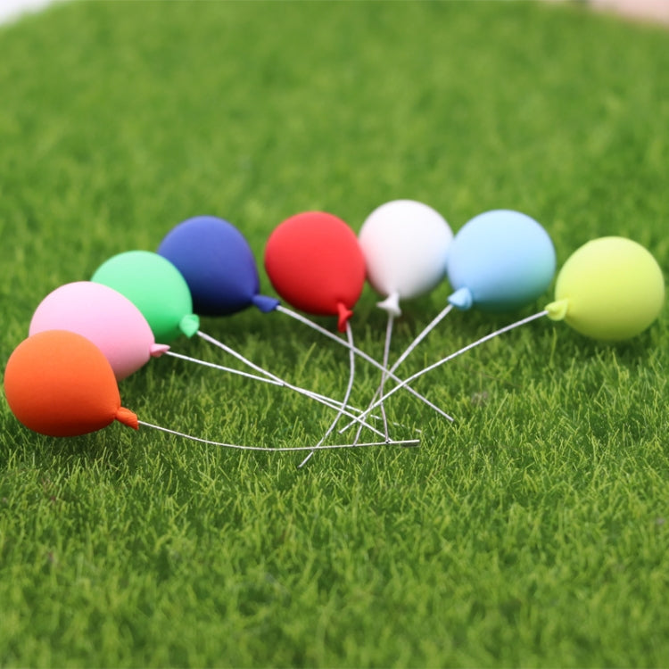 8 mini balloon decorations set on green grass with mixed-color balloon heads