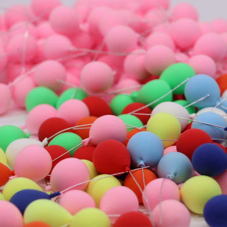 Close-up of assorted mini balloon decorations with many pink, red, green, and blue balloons