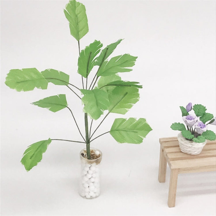 Mini dollhouse banana tree plant with green leaves in white pebble vase