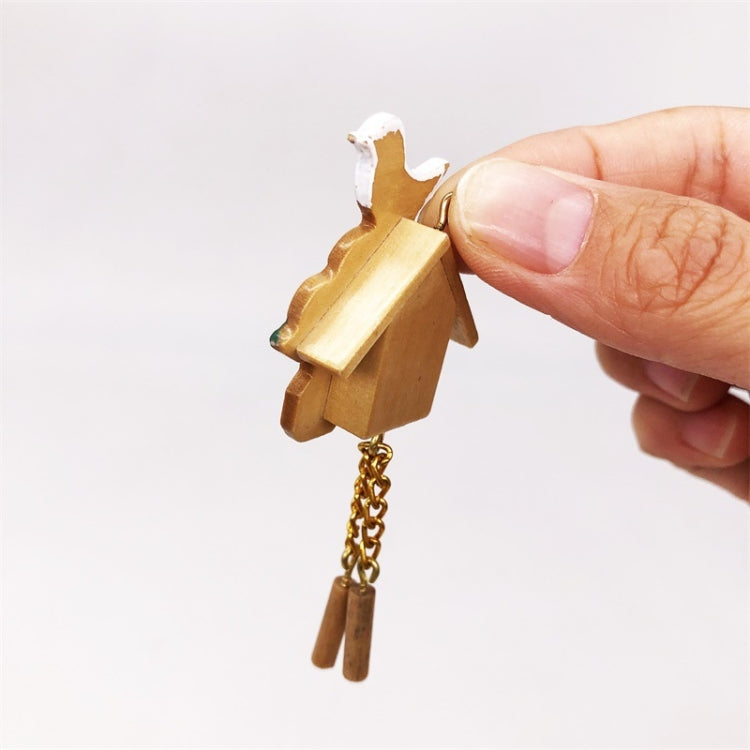 Mini wooden birdhouse clock side view with white bird top and gold chain weights