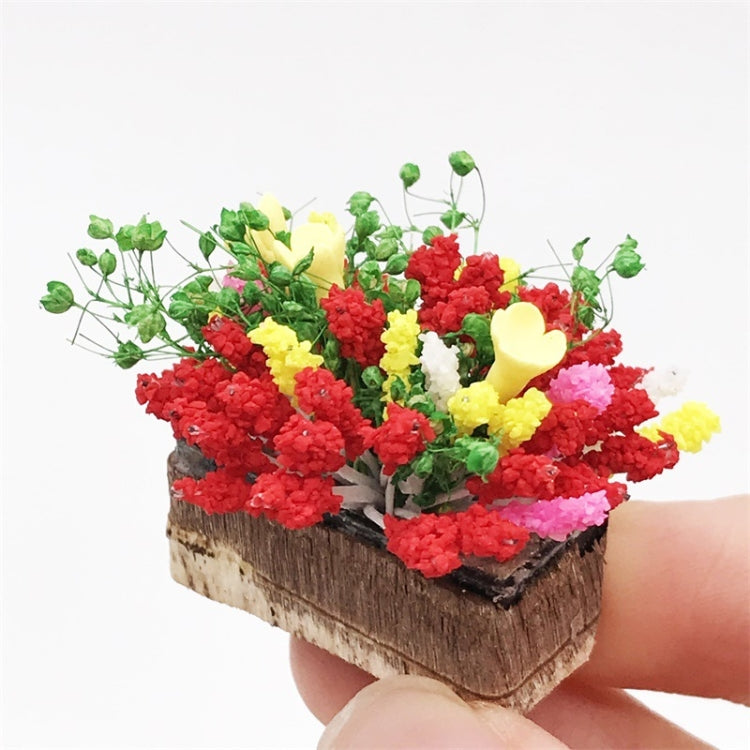 Mini clay flower arrangement in dark planter, red, yellow, and green blossoms with stems