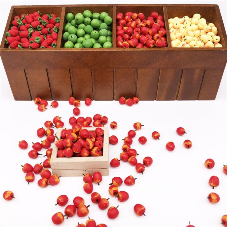 Miniature fruit apples in a wooden tray with compartments and loose pieces below.
