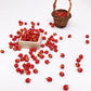 Miniature red apples spilled from small wooden crates and a woven basket.