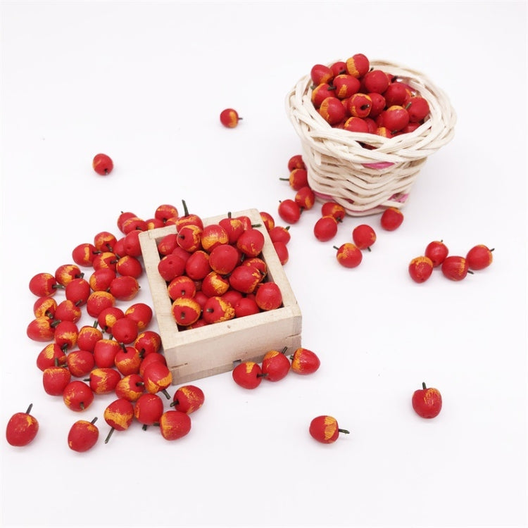 Miniature red apples in a wicker basket and wooden crate, with loose pieces.